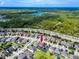 Panoramic aerial view of a suburban home near a highway and lakes, surrounded by lush greenery at 1601 Fox Grape Loop, Lutz, FL 33558