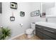Modern half bathroom with stylish decor, a sleek vanity, and decorative wall art, adding a touch of elegance at 1601 Fox Grape Loop, Lutz, FL 33558