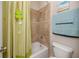 Bathroom showing shower with beige tile, vanity and toilet at 1601 Fox Grape Loop, Lutz, FL 33558