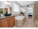 This bathroom boasts dual sinks, a luxurious soaking tub, and a separate walk-in shower at 1601 Fox Grape Loop, Lutz, FL 33558