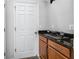 A bathroom features a black granite countertop, brown wood cabinets, and decorative objects at 1601 Fox Grape Loop, Lutz, FL 33558