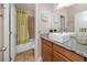 Bathroom featuring granite countertop vanity, vessel sink, and shower at 1601 Fox Grape Loop, Lutz, FL 33558