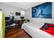 Bedroom with Hardwood floors, large wall tapestry, computer and gaming setup at 1601 Fox Grape Loop, Lutz, FL 33558