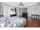 A large main bedroom features hardwood floors, a television and a ceiling fan at 1601 Fox Grape Loop, Lutz, FL 33558