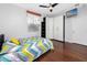 Cozy bedroom featuring hardwood floors, closet space and a ceiling fan at 1601 Fox Grape Loop, Lutz, FL 33558