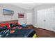 Bedroom with hardwood floors, bed and television at 1601 Fox Grape Loop, Lutz, FL 33558