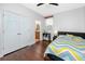 Bedroom with hardwood floors, ceiling fan, walk in closet, and updated bathroom at 1601 Fox Grape Loop, Lutz, FL 33558