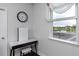 Bright bedroom featuring hardwood floors, vanity and scenic pond view window at 1601 Fox Grape Loop, Lutz, FL 33558