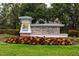 An attractive stone sign at the entrance to the Long Lake Ranch community with colorful landscaping at 1601 Fox Grape Loop, Lutz, FL 33558
