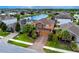 Beautiful two-story home boasts mature landscaping, brick driveway, and serene water views at 1601 Fox Grape Loop, Lutz, FL 33558