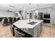 Modern kitchen with a large center island, stainless steel appliances, and pendant lighting, creating a sleek and functional space at 1601 Fox Grape Loop, Lutz, FL 33558
