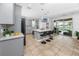 Stylish kitchen with gray cabinets, a large island, and a seamless transition to outdoor living at 1601 Fox Grape Loop, Lutz, FL 33558