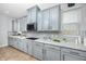 Modern kitchen featuring sleek gray cabinets, subway tile backsplash, and ample counter space at 1601 Fox Grape Loop, Lutz, FL 33558