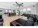 Bright living room with an open floor plan, connecting to the kitchen and dining area, perfect for modern living and entertaining at 1601 Fox Grape Loop, Lutz, FL 33558