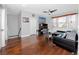 A large living room features hardwood floors, a comfortable couch and natural light at 1601 Fox Grape Loop, Lutz, FL 33558