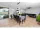 Open concept living area featuring tile flooring, a dining table, and a comfortable black leather sofa, ideal for Gathering gatherings at 1601 Fox Grape Loop, Lutz, FL 33558