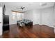 Spacious living room featuring hardwood floors, a modern couch, and bright natural light at 1601 Fox Grape Loop, Lutz, FL 33558