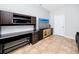 Home office featuring built-in cabinetry, a desk, and a television, providing a functional and organized workspace at 1601 Fox Grape Loop, Lutz, FL 33558