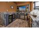View of a complete outdoor kitchen area with stainless appliances, granite counters, and a wall-mounted TV at 1601 Fox Grape Loop, Lutz, FL 33558