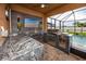 Screened patio includes a full kitchen with granite countertops, a grill, and a pool at 1601 Fox Grape Loop, Lutz, FL 33558