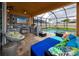 Screened patio features a full kitchen, outdoor seating, pool, and ceiling fans at 1601 Fox Grape Loop, Lutz, FL 33558