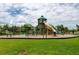 A large playground with slides, climbing structures, and swings for children at Long Lake Ranch community at 1601 Fox Grape Loop, Lutz, FL 33558