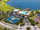 Aerial view of the community pool and tennis courts at Long Lake Ranch, perfect for recreation and relaxation at 1601 Fox Grape Loop, Lutz, FL 33558