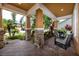 Spacious front porch with brick columns and a comfortable seating area, perfect for relaxing at 1601 Fox Grape Loop, Lutz, FL 33558