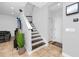 Staircase with wood steps and white risers, leading to the upper level of the home, next to the living room at 1601 Fox Grape Loop, Lutz, FL 33558