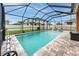 View of the swimming pool and lounge area, surrounded by a screened enclosure at 1601 Fox Grape Loop, Lutz, FL 33558