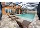 The patio area features a pool, outdoor lounge chairs, and dining furniture at 1601 Fox Grape Loop, Lutz, FL 33558