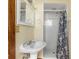 This charming bathroom features a pedestal sink, a mirror, and a walk-in shower at 1701 N Tampania Ave, Tampa, FL 33607