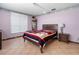 Comfortable bedroom features warm tile flooring, horizontal blinds, and relaxing decor at 1701 N Tampania Ave, Tampa, FL 33607
