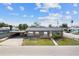 Charming single-story home featuring a carport, fenced yard, and inviting front porch, perfect for enjoying the neighborhood view at 1701 N Tampania Ave, Tampa, FL 33607