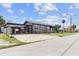 View of the home's side and attached carport featuring ample parking space and additional storage at 1701 N Tampania Ave, Tampa, FL 33607