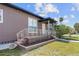Cozy front porch with decorative railings, offering a welcoming entrance to this charming home at 1701 N Tampania Ave, Tampa, FL 33607