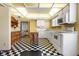 Functional kitchen with vintage checkered floors, ample counter space, and built-in appliances at 1701 N Tampania Ave, Tampa, FL 33607