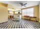 Open concept kitchen with checkered floors, white appliances, and generous counter space at 1701 N Tampania Ave, Tampa, FL 33607