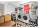 Functional laundry room with washer, dryer, shelving, and laundry sink at 1701 N Tampania Ave, Tampa, FL 33607