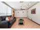 Spacious living room with tile floors, a comfortable sofa, and a large window for ample natural light at 1701 N Tampania Ave, Tampa, FL 33607