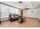 Inviting living room featuring tile flooring, a comfortable leather sofa, and plenty of natural light at 1701 N Tampania Ave, Tampa, FL 33607