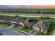 Aerial view of homes with tile roofs, paved driveways, and backyard solar panels on a sunny day at 20828 Cattail Blvd, Venice, FL 34292