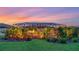 Backyard with lush tropical landscaping, exterior lighting, and screened lanai at 20828 Cattail Blvd, Venice, FL 34292