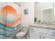 Bathroom with a patterned shower curtain, granite counter, and white vanity at 20828 Cattail Blvd, Venice, FL 34292