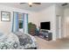 Bedroom features a fireplace, mounted television, carpet floors, a dresser, and crown molding at 20828 Cattail Blvd, Venice, FL 34292