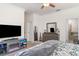 Bedroom with TV, fireplace, large dresser, crown molding, carpet, and access to the bathroom at 20828 Cattail Blvd, Venice, FL 34292