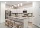 Kitchen with white cabinets, stainless steel appliances, granite countertops, and a large central island at 20828 Cattail Blvd, Venice, FL 34292