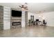 Living room featuring a stone accent wall with a fireplace, built-in shelving, and nearby work space at 20828 Cattail Blvd, Venice, FL 34292