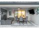 Covered patio area with comfortable seating and an outdoor dining setup at 20828 Cattail Blvd, Venice, FL 34292