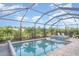 Enclosed pool area with a heated spa and comfortable lounge chairs at 20828 Cattail Blvd, Venice, FL 34292